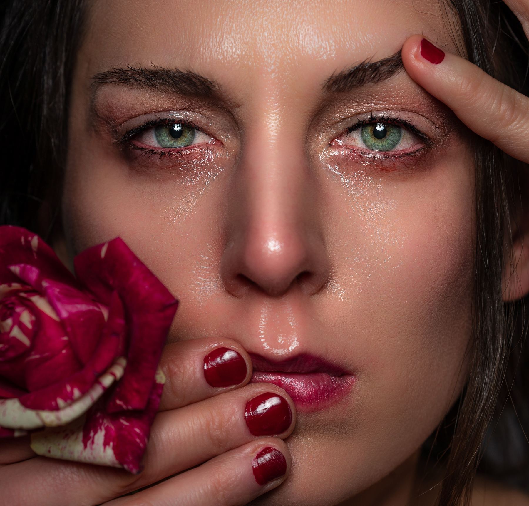 Close-up portrait with tears and a rose