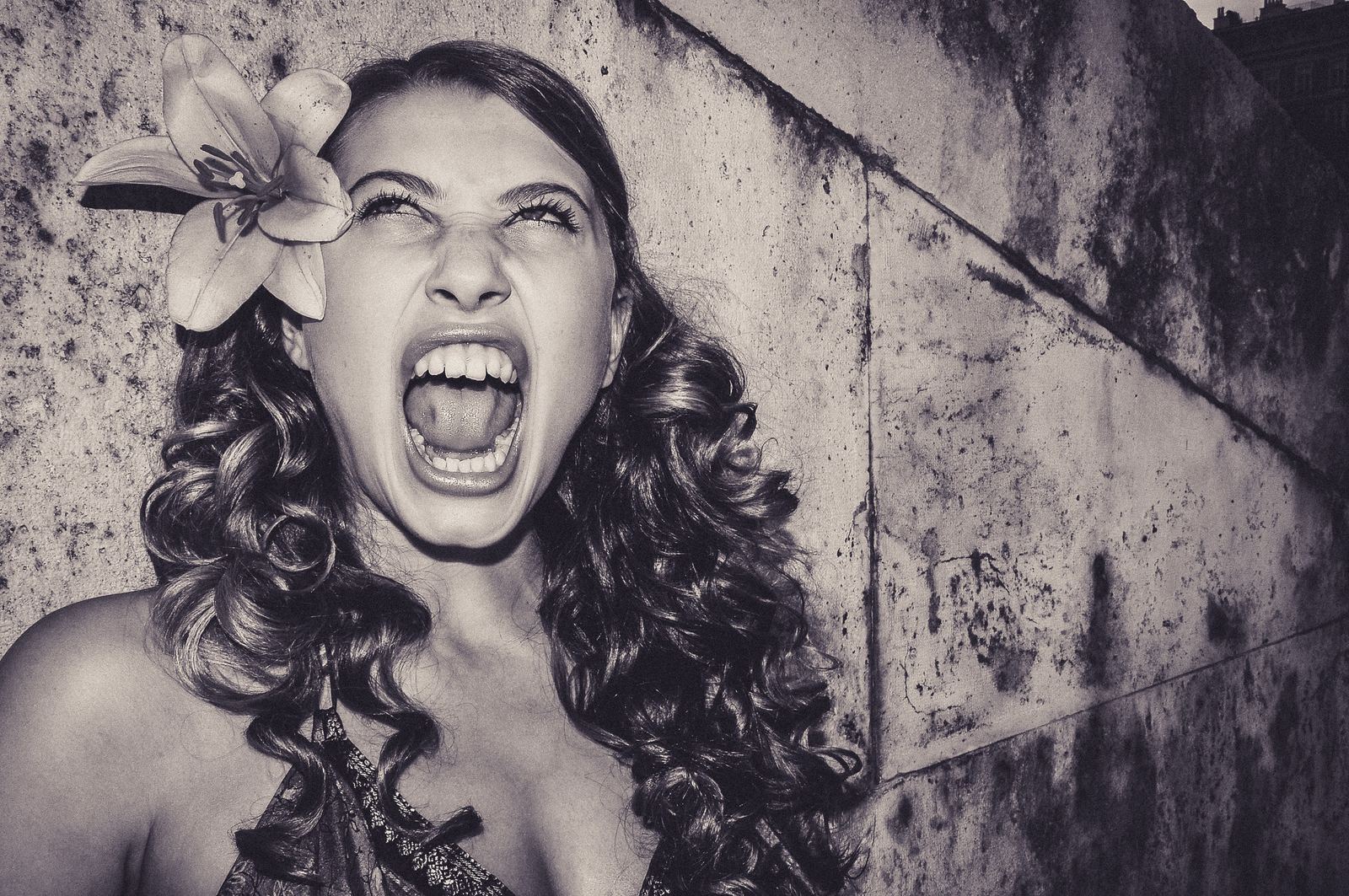 Woman screaming with a lily in her hair