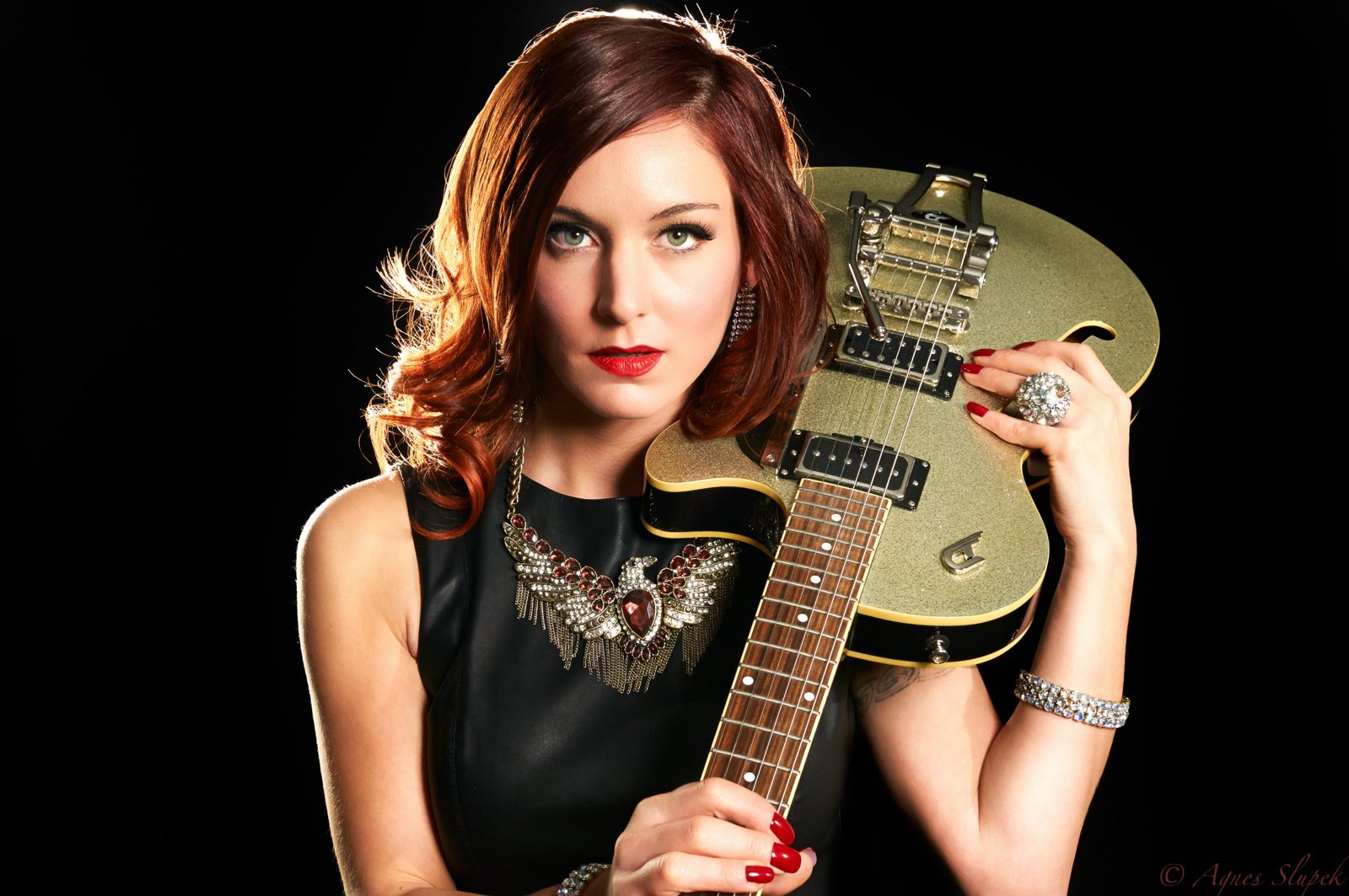 Musician portrait with a gold glitter guitar
