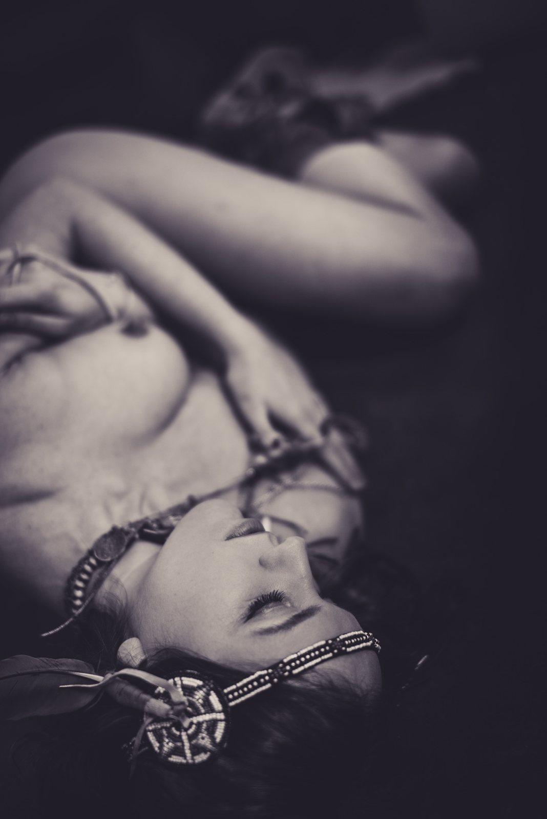 Reclining woman with beaded headband in black and white
